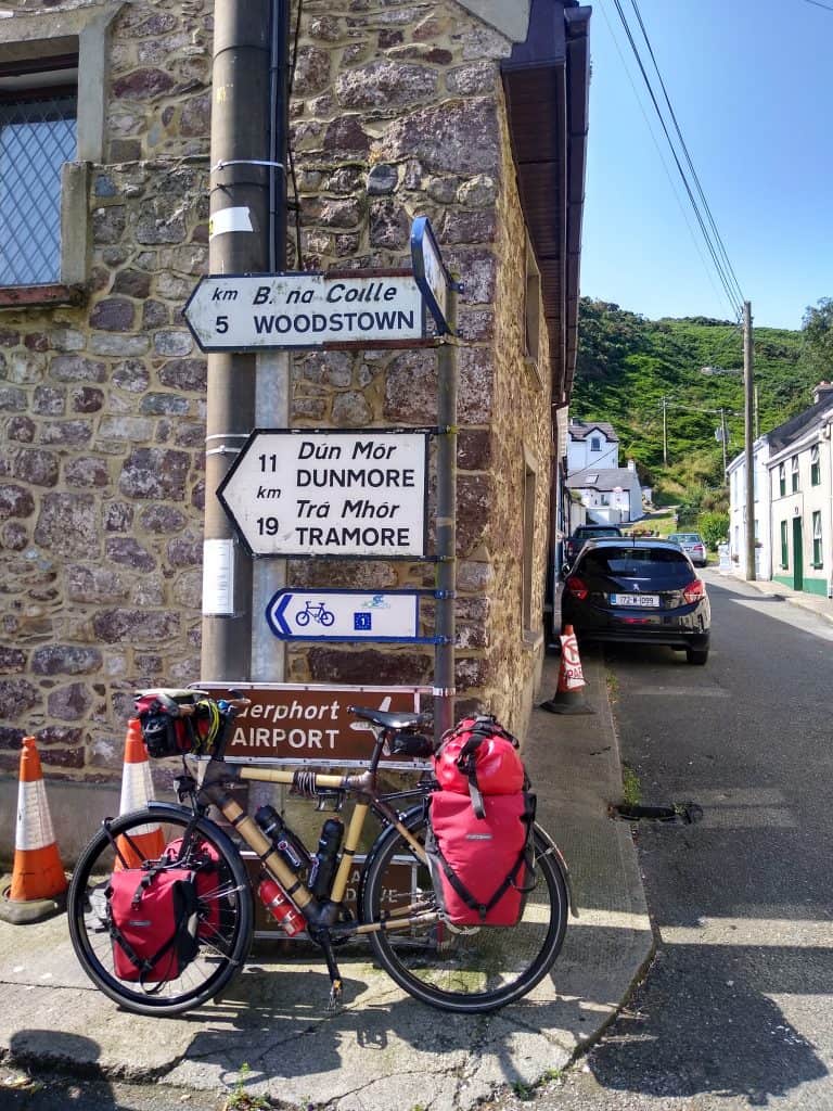 Bamboo touring bike leaning against sign