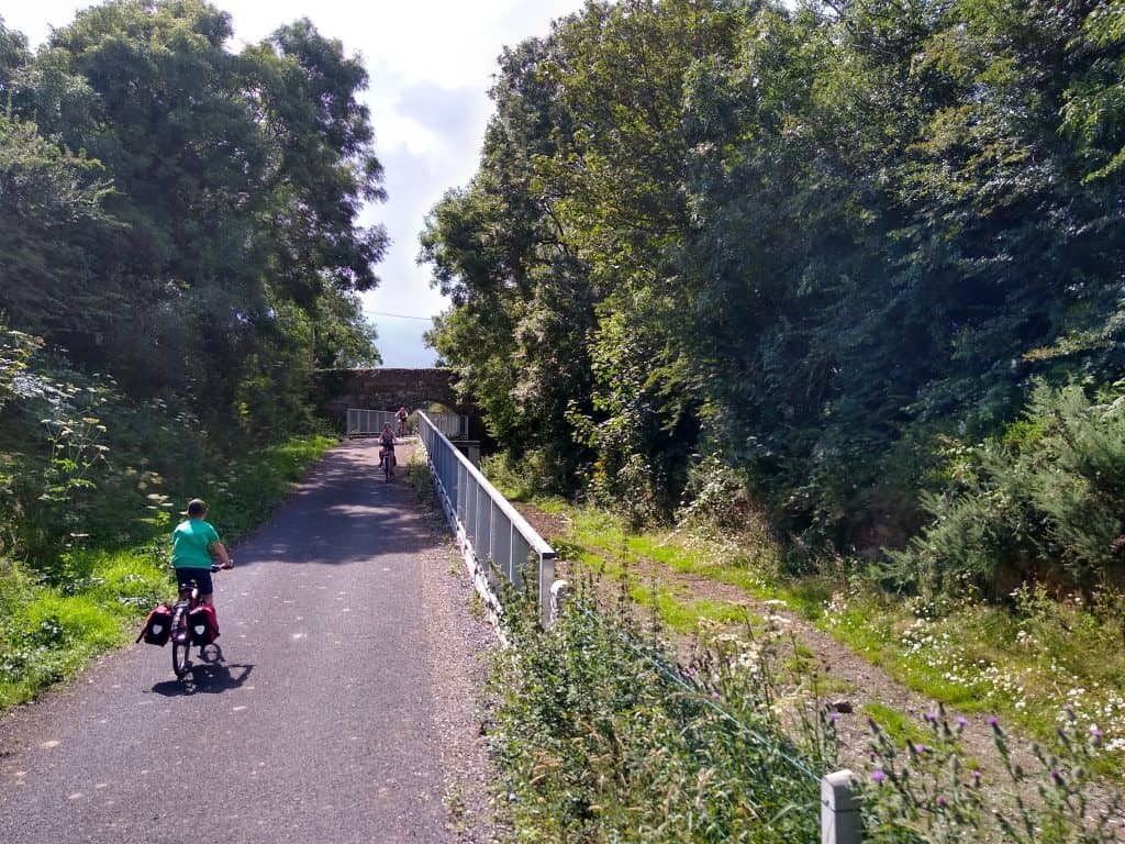 R on greenway path that goes under old railway bridge but over farm access below